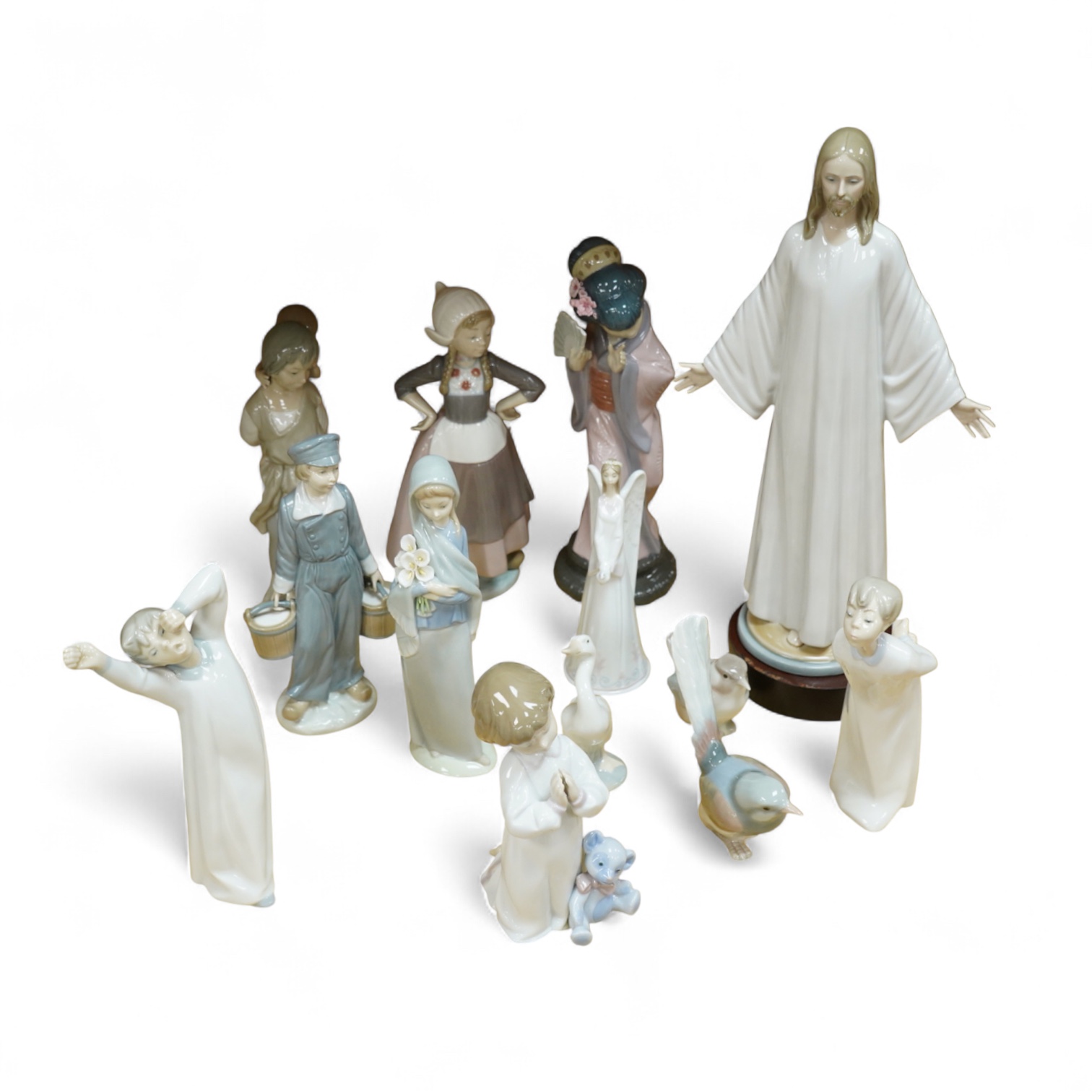 A group of Lladro figurines including: a Japanese Geisha, a model of Christ, 3 birds, various children, an angel bell etc. (all boxed) (13)